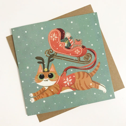 Adorable Cute Cat Christmas Card – Ginger Cat Riding a Santa Sleigh